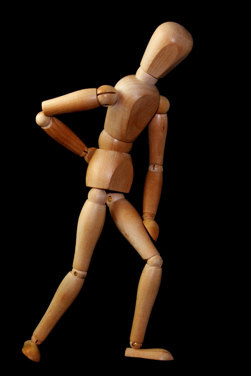 wooden figure illustrating sciatica back pain